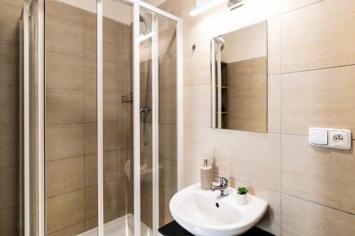 a bathroom with a sink and a shower at Apartmány Plzeň Zábělá 69 in Plzeň