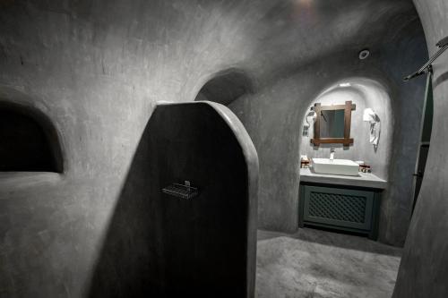 a bathroom with a sink and a mirror at Lotza Studios in Oia