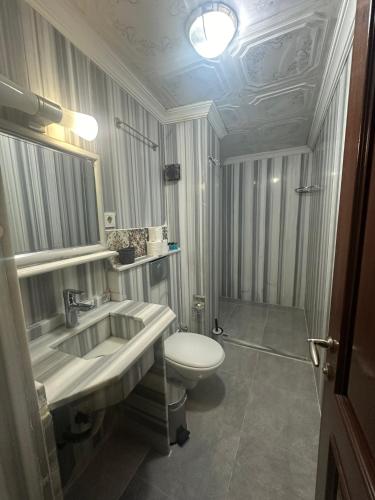 a bathroom with a sink and a toilet at Sophia Studio Apart Hotel in Istanbul