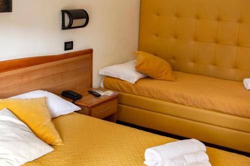 Кровать или кровати в номере Hotel La Perla Preziosa