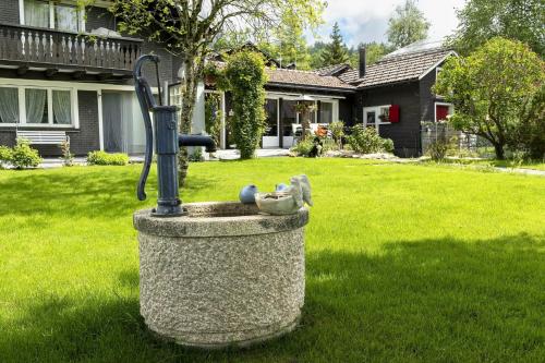 a bird fountain in the yard of a house at Capanna in Wildhaus