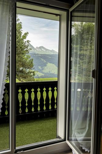 a view from a window of a balcony with a view at Capanna in Wildhaus