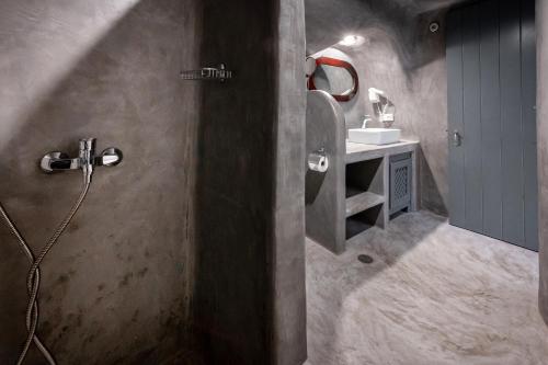 a bathroom with a shower and a sink in it at Lotza Studios in Oia