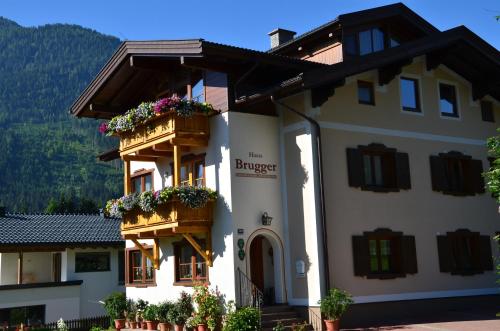 a building with flower boxes on the balconies at Gästehaus Brugger in Neukirchen am Großvenediger