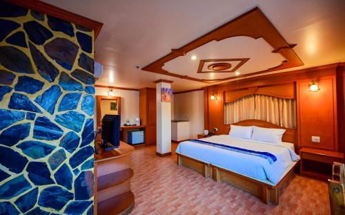 a hotel room with a bed and a large room at Tiger Complex Hotel in Patong Beach