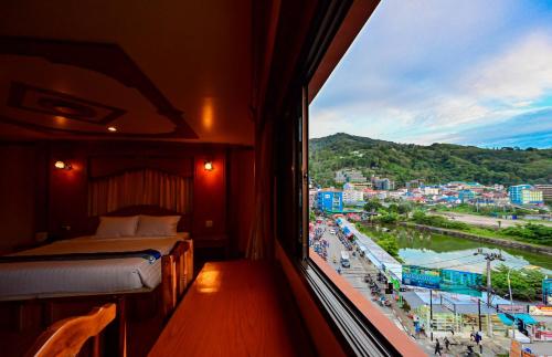 a bedroom with a bed and a view of a river at Tiger Complex Hotel in Patong Beach