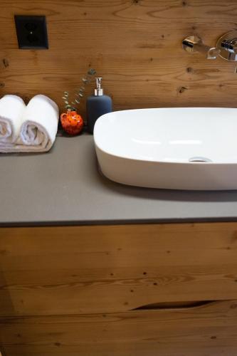 a bathroom with a sink and towels on a counter at Chalet Selun in Wildhaus