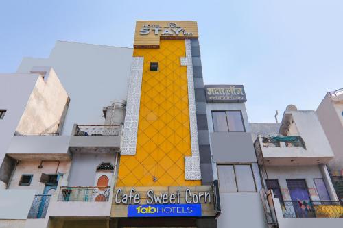 a yellow building with a sign on the side of it at FabExpress Stay Inn I in Muthiganj