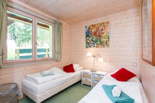 a small room with two beds and a window at Chalet Sunshine Argentiere Chamonix in Chamonix
