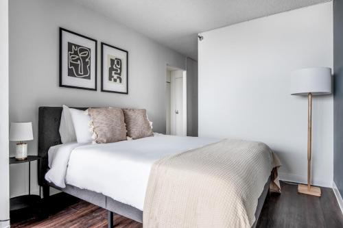 a bedroom with a bed with white sheets and pillows at Streeterville Studio w Pool Gym nr Navy Pier CHI-788 in Chicago