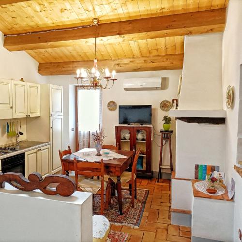 a kitchen and dining room with a table and chairs at Appartamento Ancella - Residenza la Madonina Morciano in Morciano di Romagna