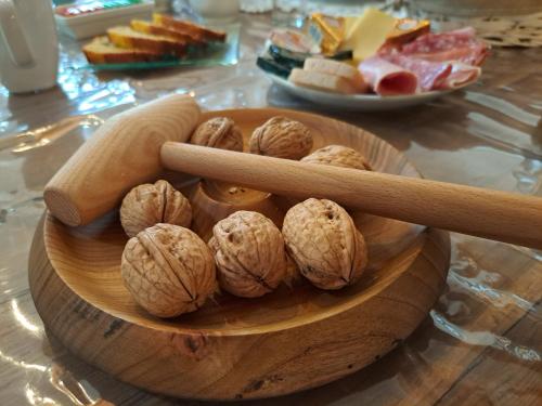 a wooden bowl of nuts on a table with two chopsticks at La Barde Montfort, votre maison d'hôtes à 4 kms de Sarlat Dordogne in Vitrac