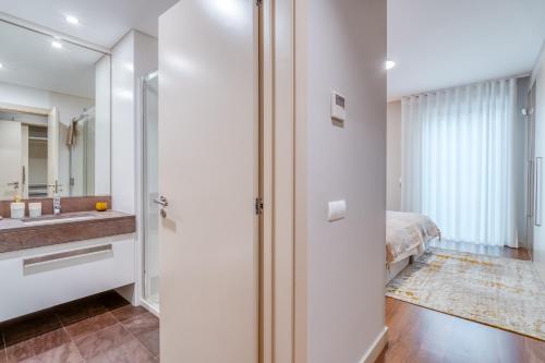 a bathroom with a sink and a mirror at Suite BK - 3 Pools - Gym - AC - Huge Balcony in Funchal