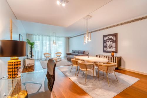 a living room with a table and chairs at Suite BK - 3 Pools - Gym - AC - Huge Balcony in Funchal