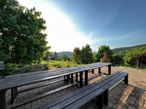 a wooden bench sitting on top of a brick patio at Villa Maximus in Jáchymov