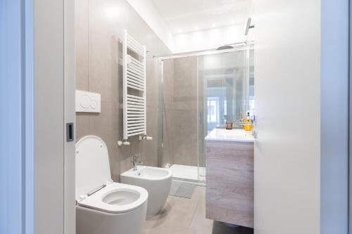 a white bathroom with a toilet and a sink at Domus Pontificia - Vaticano in Rome