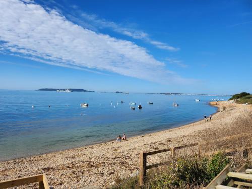 a view of a beach with boats in the water at Pemberton Avon pitch 30 in Ringstead