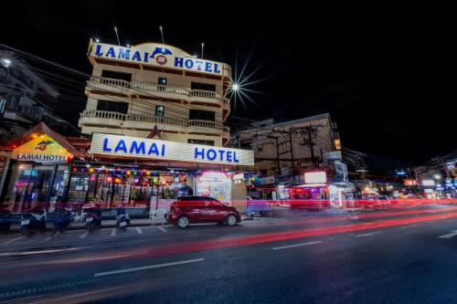 a busy city street at night with a hotel at Lamai Hotel in Patong Beach