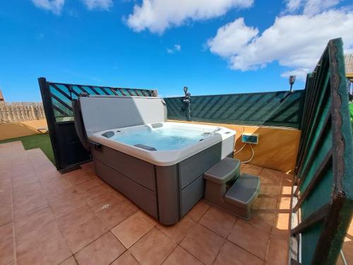 a hot tub sitting on top of a balcony at Villadunas - with luxury hot tub in Corralejo