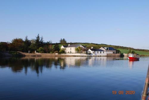 a large body of water with a house and a boat at Seapoint Lodge in Westport