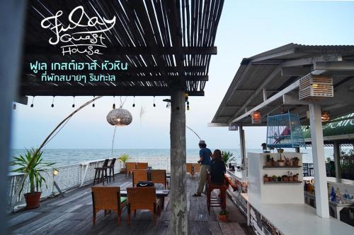 a restaurant on the beach with a view of the ocean at Fulay Guesthouse Hua Hin in Hua Hin