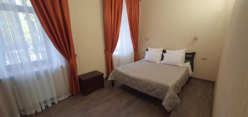 a small bedroom with a bed and a window at Centralnyi hotel in Poltava