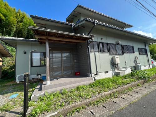 a house with a black and white at シークレットベースゆふいん in Yufuin