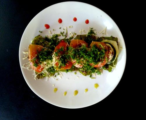 a white plate of food with vegetables and rice at Mamagoa Beach Resort in Mandrem