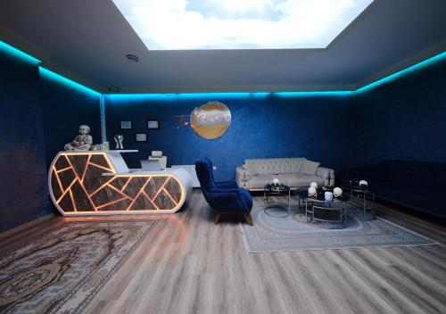 a living room with blue walls and a skylight at The Sunshine Otel & SPA in Istanbul