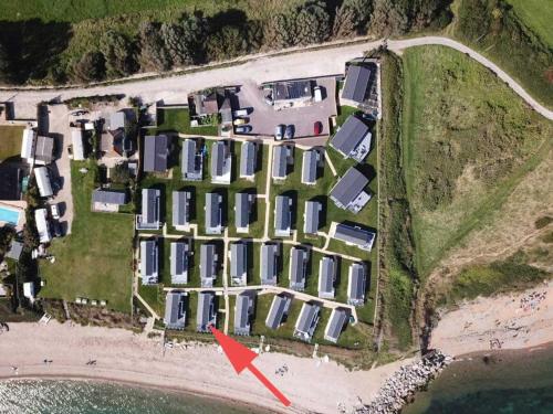 an aerial view of a house with a red arrow at Europa Willow Pitch 29 Creek Caravan Park in Ringstead