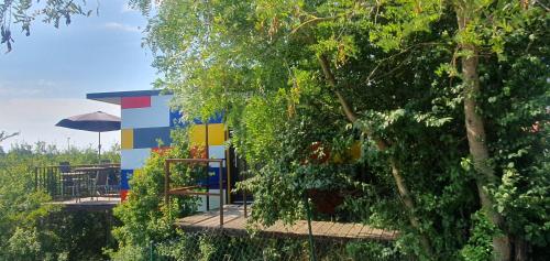 un edificio colorido en medio de los árboles en GLÜCK HOMES Baumhaus en Ippesheim