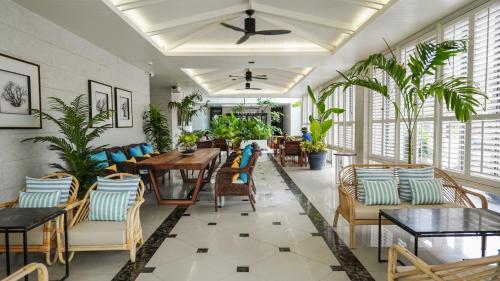 une salle à manger avec des tables, des chaises et des plantes dans l'établissement Sugar Marina Hotel - ART - Karon Beach - SHA Plus, à Karon Beach