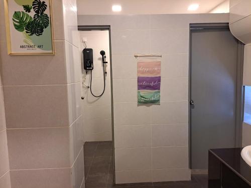 a bathroom with a shower with a phone on the wall at SCC HOTEL PJ in Petaling Jaya