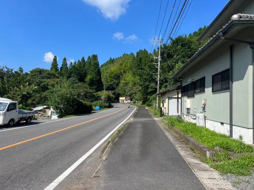 an empty road with a building on the side at シークレットベースゆふいん in Yufuin