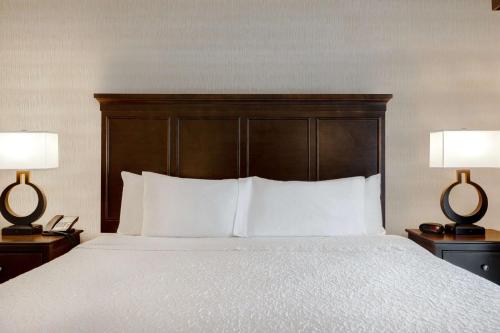 a bedroom with a large bed with two lamps at Hampton Inn & Suites San Luis Obispo in San Luis Obispo
