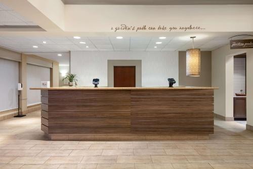 a lobby with a bar with a sign that reads i gotta put on like two at Hilton Garden Inn Montgomery East in Montgomery