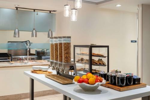 a kitchen with a counter with food on it at Hilton Garden Inn Montgomery East in Montgomery