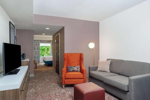 a living room with a couch and a television at Hilton Garden Inn Montgomery East in Montgomery