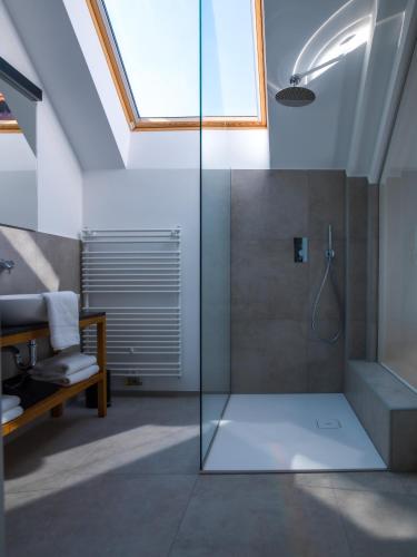 a bathroom with a shower with a glass door at Hotel Belmur in Murska Sobota