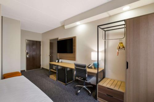 a hotel room with a bed and a desk at Clarion Pointe Sevierville-Pigeon Forge in Sevierville