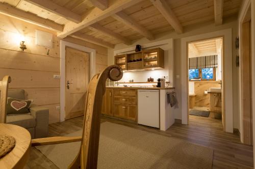 a kitchen in a log cabin with a white refrigerator at Aparthotel Bambi in Zakopane