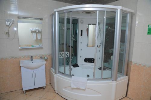 a bathroom with a shower and a sink at Debredamo Hotel in Addis Ababa