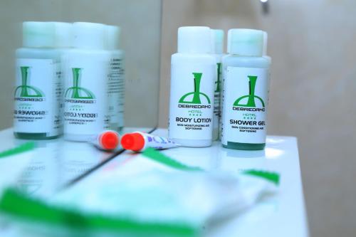 a group of bottles of sunscreen sitting on a table at Debredamo Hotel in Addis Ababa