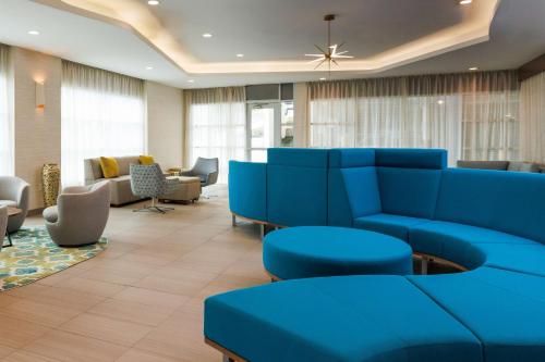 a hospital waiting room with blue couches and chairs at Hyatt Place San Carlos in San Carlos