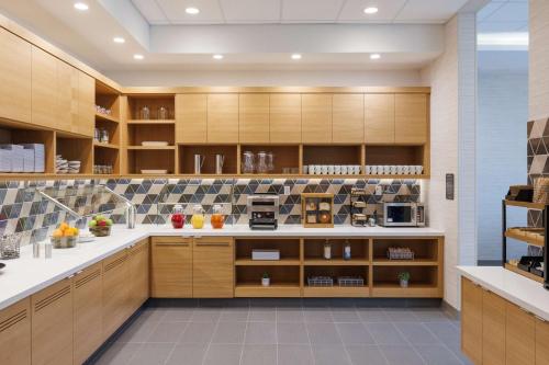 a large kitchen with wooden cabinets and appliances at Hyatt Place San Carlos in San Carlos