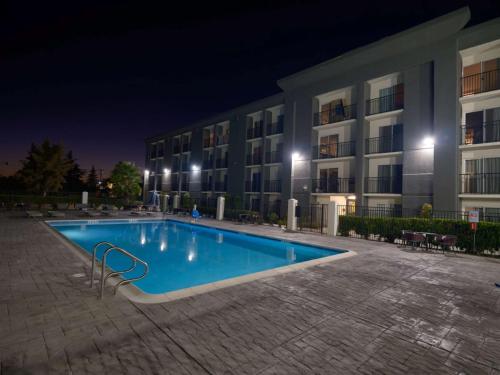 a swimming pool in front of a building at night at DoubleTree by Hilton Livermore, CA in Livermore