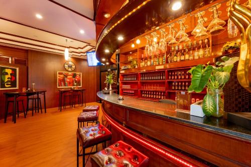 a bar with a counter and stools in a room at Lamai Hotel in Patong Beach