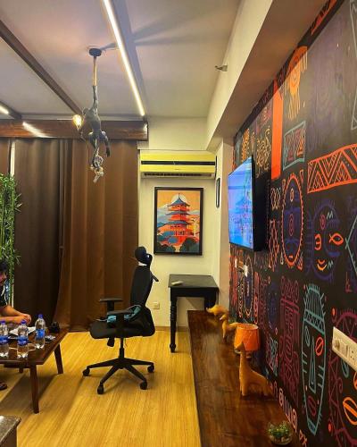 a living room with a wall covered in graffiti at The Nest Lucknow in Lucknow