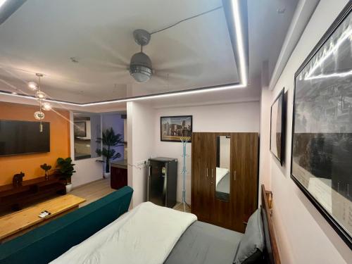 a living room with a bed and a tv at The Nest Lucknow in Lucknow