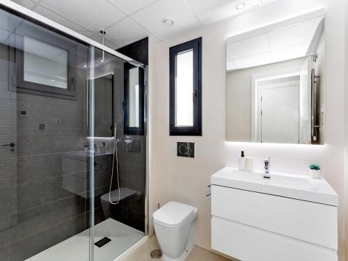 a bathroom with a toilet and a shower and a sink at Lovely first floor apartment, heating pool ! in Playa Flamenca